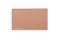 A rectangular caramel beige beauty mat, featuring the text 'THE BEAUTY MAT' printed in white at the bottom left, set against a plain white background.