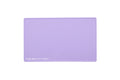A lilac purple rectangular silicone beauty mat with rounded corners and the text 'THE BEAUTY MAT' printed in white in the bottom-left corner, shown on a solid white background.