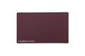 A rectangular maroon beauty mat with rounded corners and the text 'THE BEAUTY MAT' printed in white at the bottom left, shown on a plain white background.