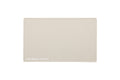 A rectangular oatmeal beige beauty mat with rounded corners and the text 'THE BEAUTY MAT' printed in white at the bottom left, shown on a solid white background.