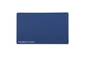 A rectangular navy blue beauty mat with rounded corners and the text 'THE BEAUTY MAT' printed in white at the bottom left, shown on a plain white background.
